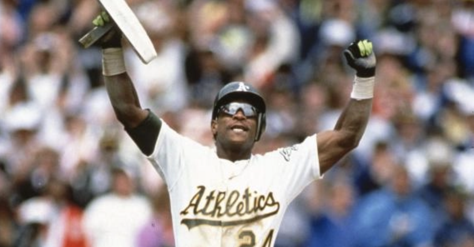 Rickey Henderson holding up a base after breaking Lou Brock's stolen base record