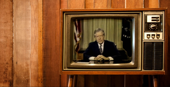 A photo of a 1970s TV with an image of Jimmy Carter delivering a speech from the Oval Office on it