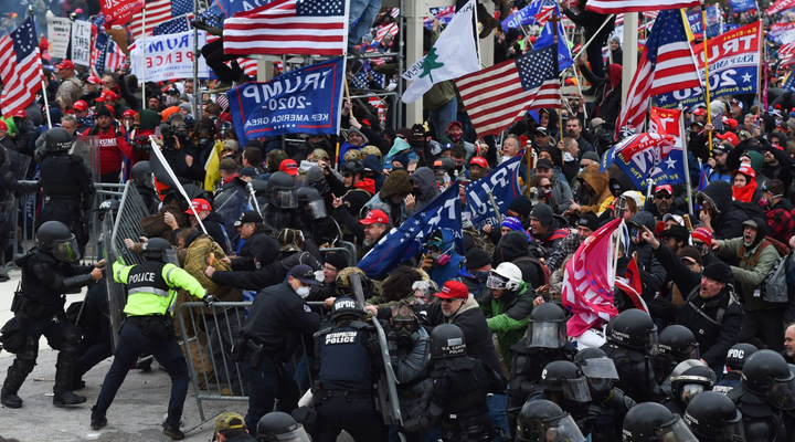 Photo of the January 6, 2021 insurrection, with rioters breaking through the police barriers