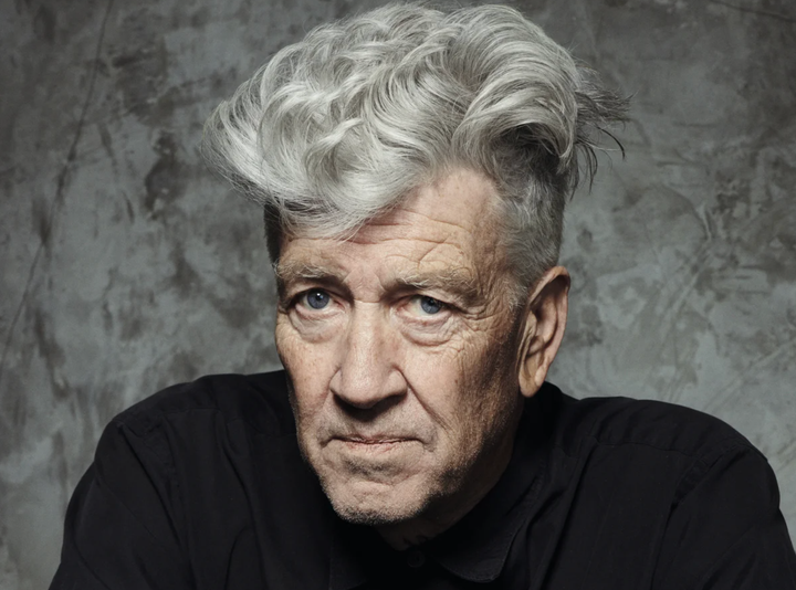 David Lynch in a black turtleneck and his typical huge silver pompadour, looking like the most interesting guy ever.