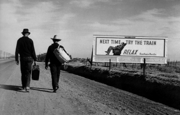 A billboard that says "Next Time Try the Train! Relax!" 