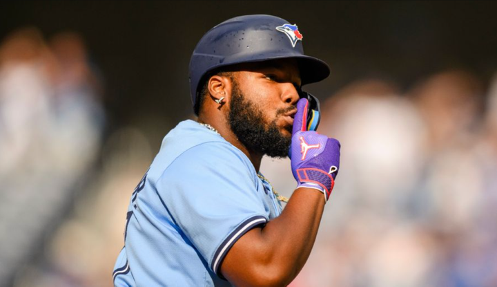 Vladimir Guerrero Jr. making the "shhh" motion, presumably after hitting a home run.